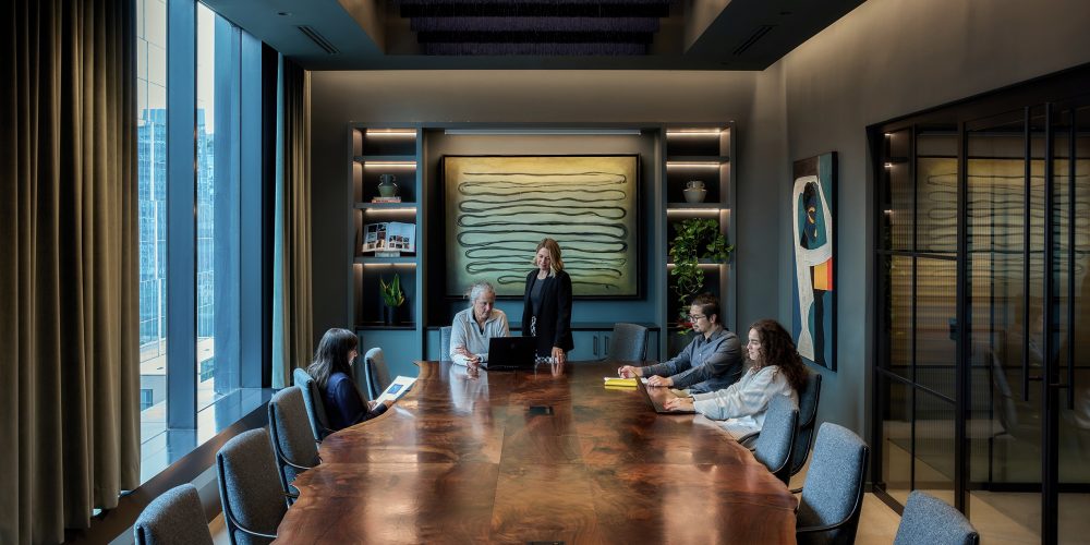 Several layers of lighting allow for the boardroom to function in various ways while continuing to hide sources from direct view of occupants.
