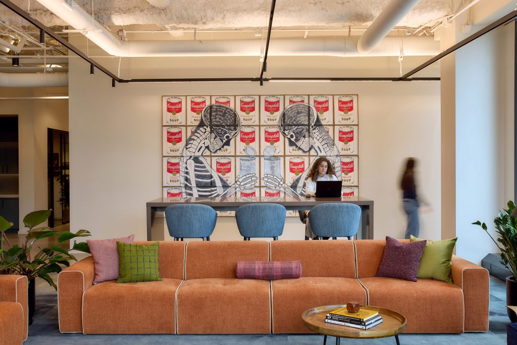 Linear wallwash inserts are used to highlight artwork without disrupting the rhythm of the track lighting arrays.