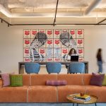 Linear wallwash inserts are used to highlight artwork without disrupting the rhythm of the track lighting arrays.