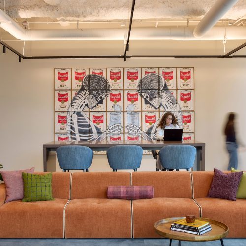 Linear wallwash inserts are used to highlight artwork without disrupting the rhythm of the track lighting arrays.