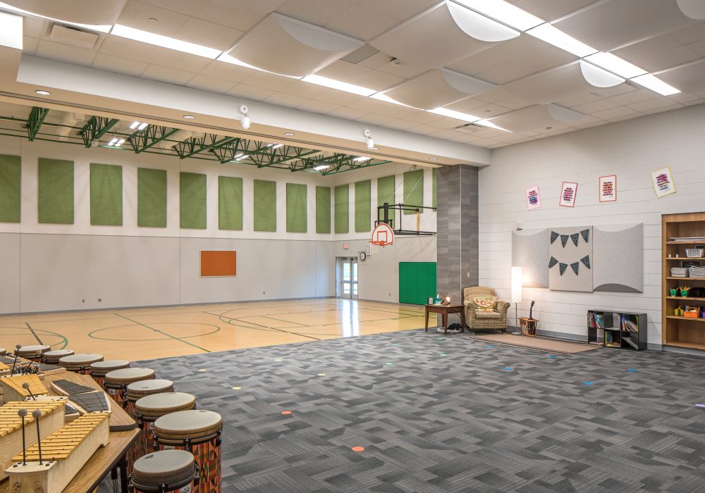 Interior shot of the dual-use gymnasium and stage area of Papillion-La Vista Ashbury Hills elementary